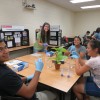 Graduate Student Emma Wallace demonstrates a plant transformation. Photo Credit: Alyssa Koehler.