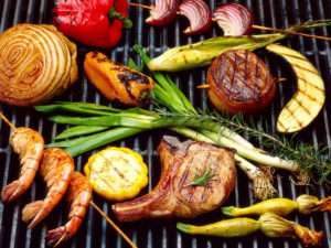 meat and vegetables on a grill