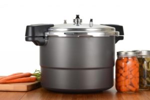 pressure canner and jars of canned vegetables
