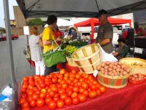 people shopping at local farmers market
