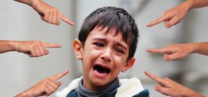 crying child being pointed at