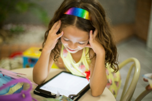 young girl looking at a tablet