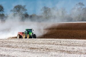 Tractor spreading lime on field